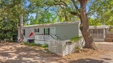 View of front of property with a sunroom and a metal roof