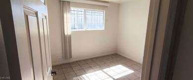 Spare room with light tile patterned flooring and