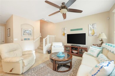 Living room featuring ceiling fan and light tile p