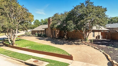 View of front side view of property with circular driveway