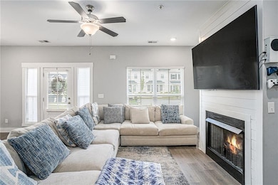 Living room featuring a large fireplace, visible v