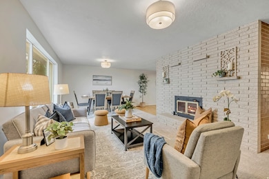 Living area featuring a fireplace and brick wall