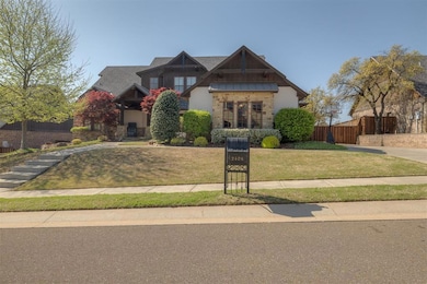 View of front of home featuring stone siding, a sh
