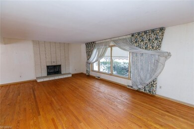 Large living room with hardwood floors and wood bu