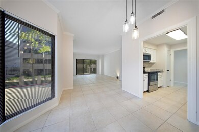 Light-filled dining area featuring large bay windows, tile flooring, and modern pendant lighting.