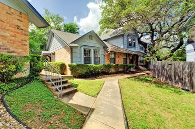 Bungalow-style home featuring fence, brick siding