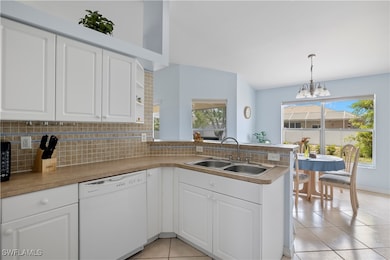 Kitchen with kitchen peninsula, dishwasher, light