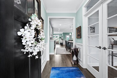 Hallway featuring ornamental molding, hardwood / w