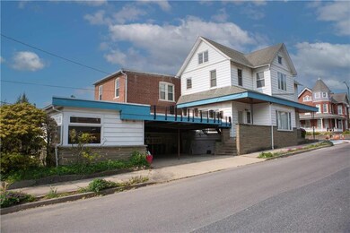 Side view showcases carport and STUDIO!
