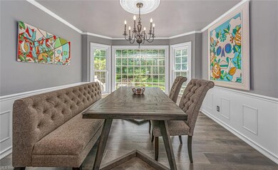 Formal dining room with bay window and crown moldi