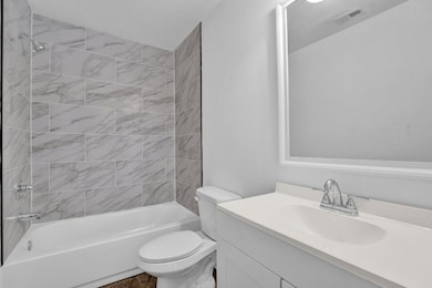Full bath with toilet, vanity, and  shower combination