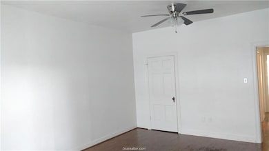 Spare room with ceiling fan, wood finished floors,
