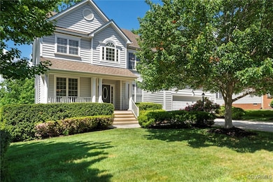 Traditional home featuring covered porch, a front