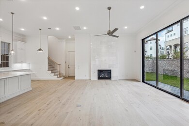 The kitchen opens to the living room with gas log