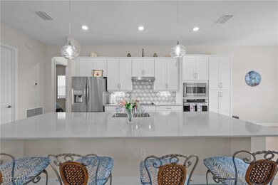 Kitchen featuring a spacious island, white cabinet
