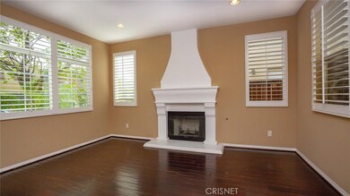 Formal living room off the entry, has a view of the trees and street.
