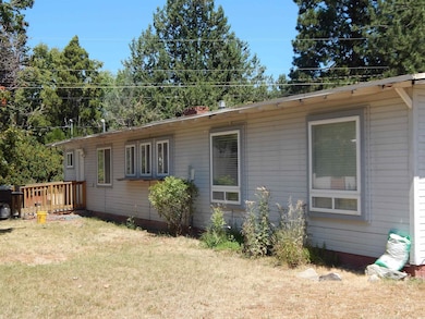 View of home's exterior featuring a yard and a deck