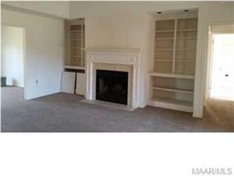 Fire place in family room with built in book shelv