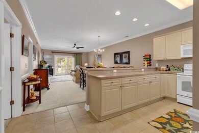 Kitchen featuring hanging light fixtures, crown mo