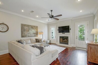 Living room with gas fireplace, crown molding & ac