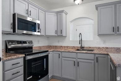 Kitchen featuring new stainless-steel range, microwave, fixtures, and refinished cabinetry