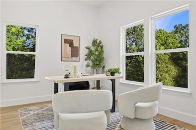 Living area featuring light wood-type flooring and a desk