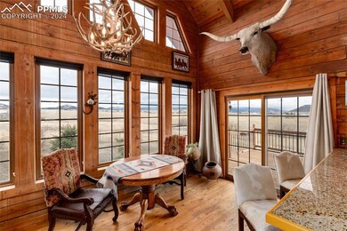 Sunroom featuring wooden ceiling, a chandelier, a 