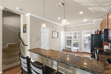 Kitchen featuring ornamental molding, dark wood-ty