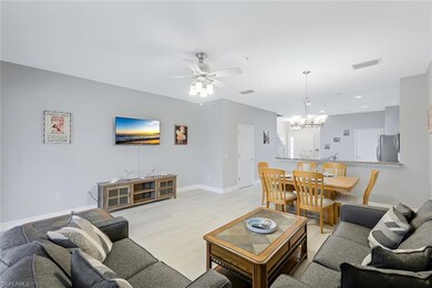 Living room with ceiling fan with notable chandeli