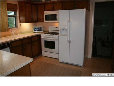KITCHEN FEATURES TILE FLOOR, SOLID SURFACE COUNTER