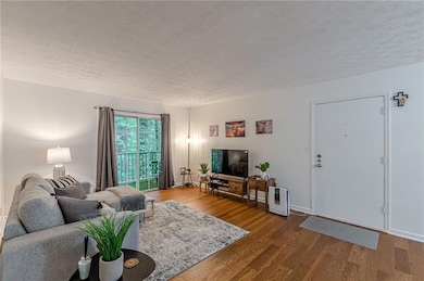 Living area with a textured ceiling and wood finished floors