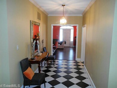 Entry. View from the front door into the living room/dining room and out to the back door.