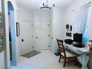 Office space featuring an inviting chandelier, lig