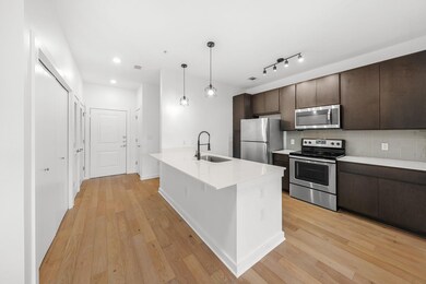 Kitchen with a sink, dark brown cabinetry, light 