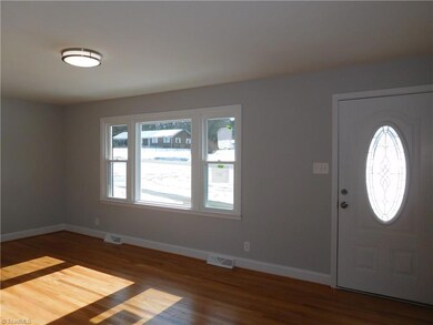 Large Living Room at front of home.  Hardwood Floors.