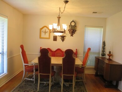 Spacious dining room with bead board under chair r