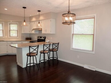 Dining room with bamboo wood flooring is open to t