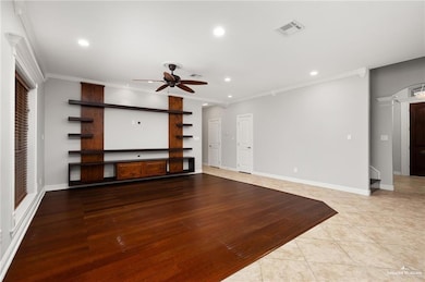 Unfurnished living room featuring visible vents, ornamental molding, ceiling fan, and recessed lighting