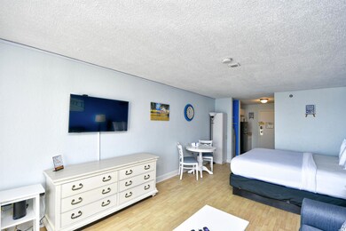 Bedroom with light wood finished floors and a textured ceiling
