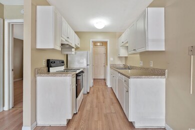Kitchen with white cabinets, white dishwasher, sin