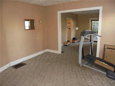 Apt 1-Living Room with hardwood floors under carpe