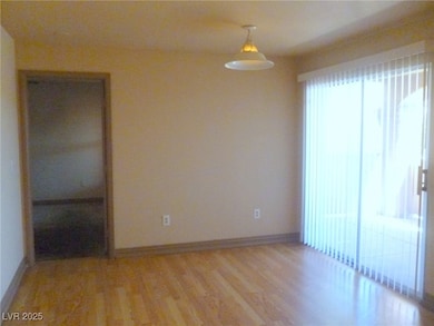 Empty room with light wood finished floors and bas