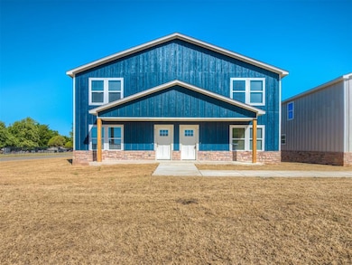 View of front of home featuring a front lawn and covered porch