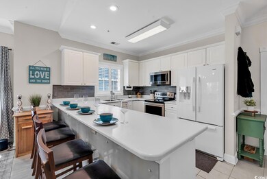 Kitchen featuring light countertops, decorative ba