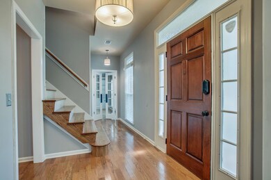  Through the front door: To the left is the den and to the right is the living room. 