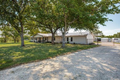 Side of house, Gated extended driveway.