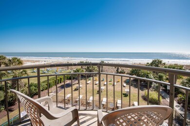 Balcony with view of water and beach