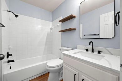 Bathroom featuring vanity, wood finished floors, 
