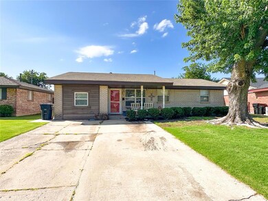View of front of property featuring brick siding, a front yard, and covered porch