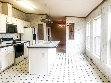 Large kitchen with 4 large windows overlooking the front yard and on a clear day there is a beautiful view.